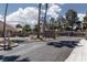 Community entrance featuring iron gates and lush greenery offers a sense of security and curb appeal at 5528 Morningcross St, Las Vegas, NV 89130