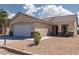 Inviting single-story home showcasing a two-car garage, desert landscaping, and a charming covered porch at 5528 Morningcross St, Las Vegas, NV 89130
