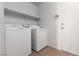 Laundry room with white washer, dryer and overhead shelf at 5528 Morningcross St, Las Vegas, NV 89130