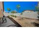 Backyard area features privacy wall, potential space for garden, and clear blue skies at 5548 Spearfish Lake Ct, Las Vegas, NV 89148