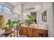 Bright bathroom with dual sinks, large mirror, and stylish plants at 5548 Spearfish Lake Ct, Las Vegas, NV 89148