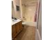 Bathroom featuring a single sink vanity, shower and bathtub combo, and tile flooring at 5855 Valley Dr # 1070, North Las Vegas, NV 89031