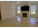 Bright living room with a cozy fireplace, neutral walls, tile flooring, and large windows for natural light at 5855 Valley Dr # 1070, North Las Vegas, NV 89031