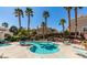 Resort-style pool area with palm trees, lounge chairs, and inviting blue water for relaxation and recreation at 5855 Valley Dr # 1070, North Las Vegas, NV 89031