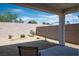Covered patio provides shade over a simple backyard with gravel and block wall fence at 6432 Linden St, North Las Vegas, NV 89086