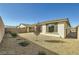 Backyard featuring desert landscaping, mature trees, and a patio area at 6432 Linden St, North Las Vegas, NV 89086