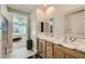 A luxurious bathroom features double sinks and wooden drawers at 6432 Linden St, North Las Vegas, NV 89086