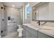 Bright bathroom featuring an elegant vanity, new fixtures, a glass-enclosed shower, and tile flooring at 6432 Linden St, North Las Vegas, NV 89086