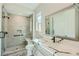 Modern bathroom with a glass shower, marble counters, and sleek black fixtures at 6432 Linden St, North Las Vegas, NV 89086