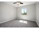 Neutral bedroom showcasing natural light, carpet flooring, and a ceiling fan at 6432 Linden St, North Las Vegas, NV 89086