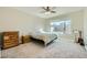 A cozy bedroom with plush carpet, ceiling fan and a bright window at 6432 Linden St, North Las Vegas, NV 89086