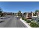 Gated community entrance with desert landscaping and well-maintained stone features for added security and curb appeal at 6432 Linden St, North Las Vegas, NV 89086