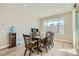 Inviting dining room boasts wood floors and a large window for natural light at 6432 Linden St, North Las Vegas, NV 89086