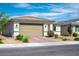 Lovely single-story house featuring a tile roof, neutral color scheme, and desert landscaping at 6432 Linden St, North Las Vegas, NV 89086