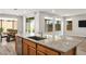 Bright kitchen featuring granite countertops, stainless steel appliances, and a large island with dining area at 6432 Linden St, North Las Vegas, NV 89086
