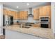 Kitchen featuring stainless steel appliances, granite counters, and light wood cabinets at 6432 Linden St, North Las Vegas, NV 89086