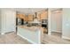 Modern kitchen with stainless steel appliances, a center island, and ample cabinet space at 6432 Linden St, North Las Vegas, NV 89086