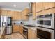 Spacious kitchen equipped with stainless steel appliances, double ovens, and ample cabinet space at 6432 Linden St, North Las Vegas, NV 89086