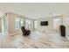 Spacious living area featuring hardwood floors and large windows for natural light at 6432 Linden St, North Las Vegas, NV 89086