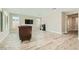 Bright living room featuring hardwood floors, ample natural light, and a modern TV setup at 6432 Linden St, North Las Vegas, NV 89086
