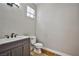 Neutral bathroom with a dark sink cabinet and modern fixtures at 6747 Gold Yarrow St, Las Vegas, NV 89148
