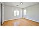 Bright bedroom featuring laminate flooring and neutral paint with multiple windows for natural light and a spacious closet at 6747 Gold Yarrow St, Las Vegas, NV 89148