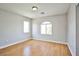 Bright bedroom featuring laminate flooring, neutral paint, and ample natural light from multiple windows for a comfortable space at 6747 Gold Yarrow St, Las Vegas, NV 89148