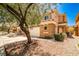 Two-story tan home with desert landscaping and a two-car garage at 6747 Gold Yarrow St, Las Vegas, NV 89148