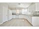 Updated kitchen with white cabinets, modern appliances and granite countertops at 6747 Gold Yarrow St, Las Vegas, NV 89148