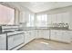 Well-lit kitchen featuring white cabinets, modern appliances, and granite countertops at 6747 Gold Yarrow St, Las Vegas, NV 89148