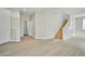 Open living room with wood-look floors and staircase to upper level at 6747 Gold Yarrow St, Las Vegas, NV 89148