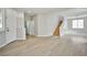 Open living room with wood-look floors and stairway with light walls and trim at 6747 Gold Yarrow St, Las Vegas, NV 89148