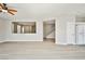 Spacious living room with light-tone flooring, neutral paint, and an open staircase for a bright and modern feel at 6747 Gold Yarrow St, Las Vegas, NV 89148