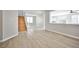 Open living room with wood-look floors leading into kitchen at 6747 Gold Yarrow St, Las Vegas, NV 89148