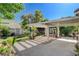 Beautiful backyard with covered patio, lush lawn, mature trees, and well-maintained landscaping at 7109 Deepriver Cir, Las Vegas, NV 89129