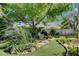 Lush backyard oasis with a tranquil pond, mature trees, and manicured lawn at 7109 Deepriver Cir, Las Vegas, NV 89129