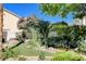 Picturesque backyard featuring a serene pond, lush greenery, mature trees, and impeccable landscaping at 7109 Deepriver Cir, Las Vegas, NV 89129