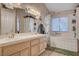 Well-lit bathroom with double sinks and a tub, providing a functional and stylish space at 7109 Deepriver Cir, Las Vegas, NV 89129