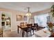 Bright dining room with natural light, a chandelier, and a view into the adjacent living area at 7109 Deepriver Cir, Las Vegas, NV 89129