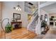 Inviting entryway featuring hardwood floors, carpeted stairs, and an elegant chandelier at 7109 Deepriver Cir, Las Vegas, NV 89129
