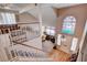 Bright entryway with a decorative window, leading into the living area and upstairs at 7109 Deepriver Cir, Las Vegas, NV 89129