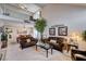 Spacious living room featuring vaulted ceilings, a decorative tree, and a seamless flow into the dining area at 7109 Deepriver Cir, Las Vegas, NV 89129