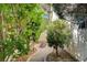 Charming pathway leading to the side of the house, surrounded by lush greenery and mature landscaping at 7109 Deepriver Cir, Las Vegas, NV 89129