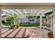 Inviting covered patio overlooking a beautifully landscaped backyard with lush greenery at 7109 Deepriver Cir, Las Vegas, NV 89129