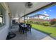 Covered back patio with ceiling fan, complete with dining furniture overlooking the backyard at 7260 Grace Estate Ave, Las Vegas, NV 89113