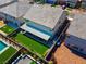 Rear aerial view of the property features a covered patio, lush lawn, and colorful landscaping, perfect for outdoor enjoyment at 7260 Grace Estate Ave, Las Vegas, NV 89113