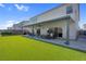 Spacious backyard with manicured lawn, covered patio, and comfortable seating area at 7260 Grace Estate Ave, Las Vegas, NV 89113