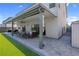 Beautiful backyard with manicured lawn, stone patio, and comfortable outdoor seating at 7260 Grace Estate Ave, Las Vegas, NV 89113