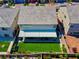 View of the home's back exterior, showcasing the lawn, covered patio, and tasteful landscaping for outdoor living at 7260 Grace Estate Ave, Las Vegas, NV 89113