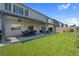 Lush backyard featuring manicured lawn, stone patio, and a covered patio dining area at 7260 Grace Estate Ave, Las Vegas, NV 89113